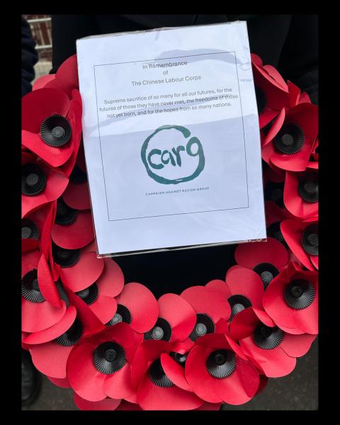 A wreath made from red paper poppies with a note representing Chinese Labour Corps