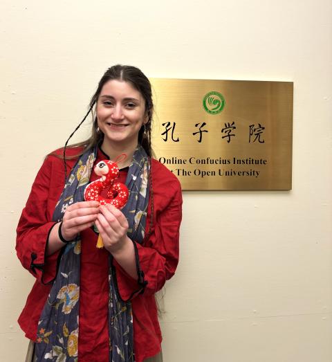 A picture of Daisy standing in front of the OCI office sign